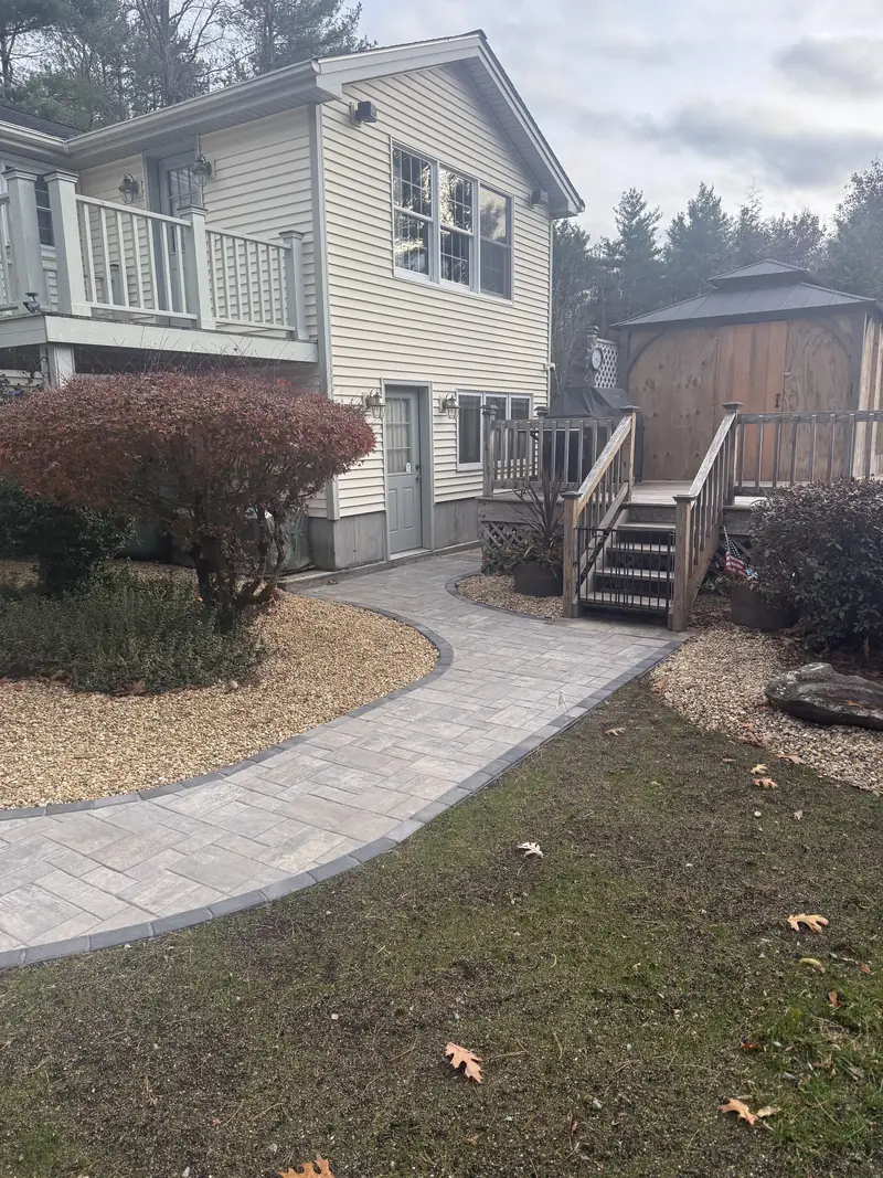 New paver walkway leading to a back deck