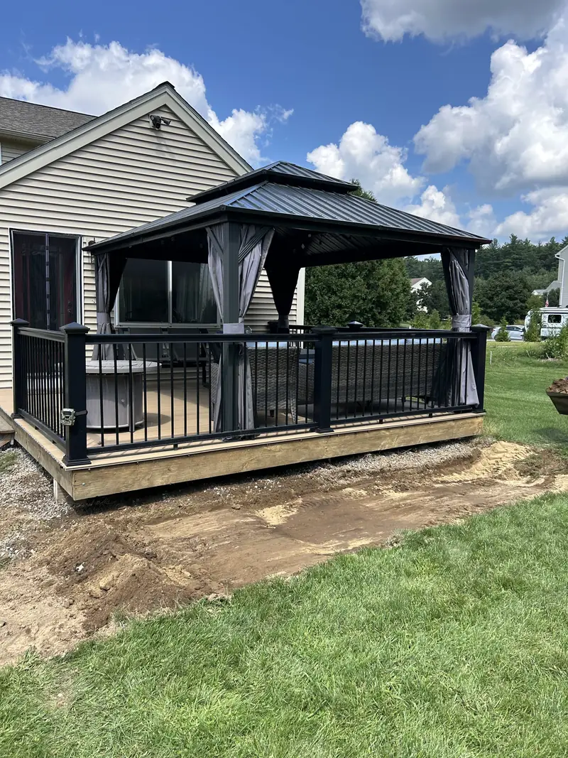 Deck with a gazebo next to a fresh lawn