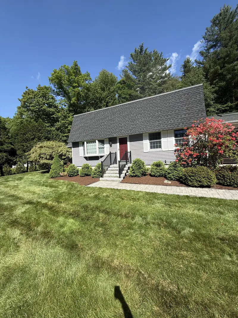 Home with fresh plantings and a striped front lawn