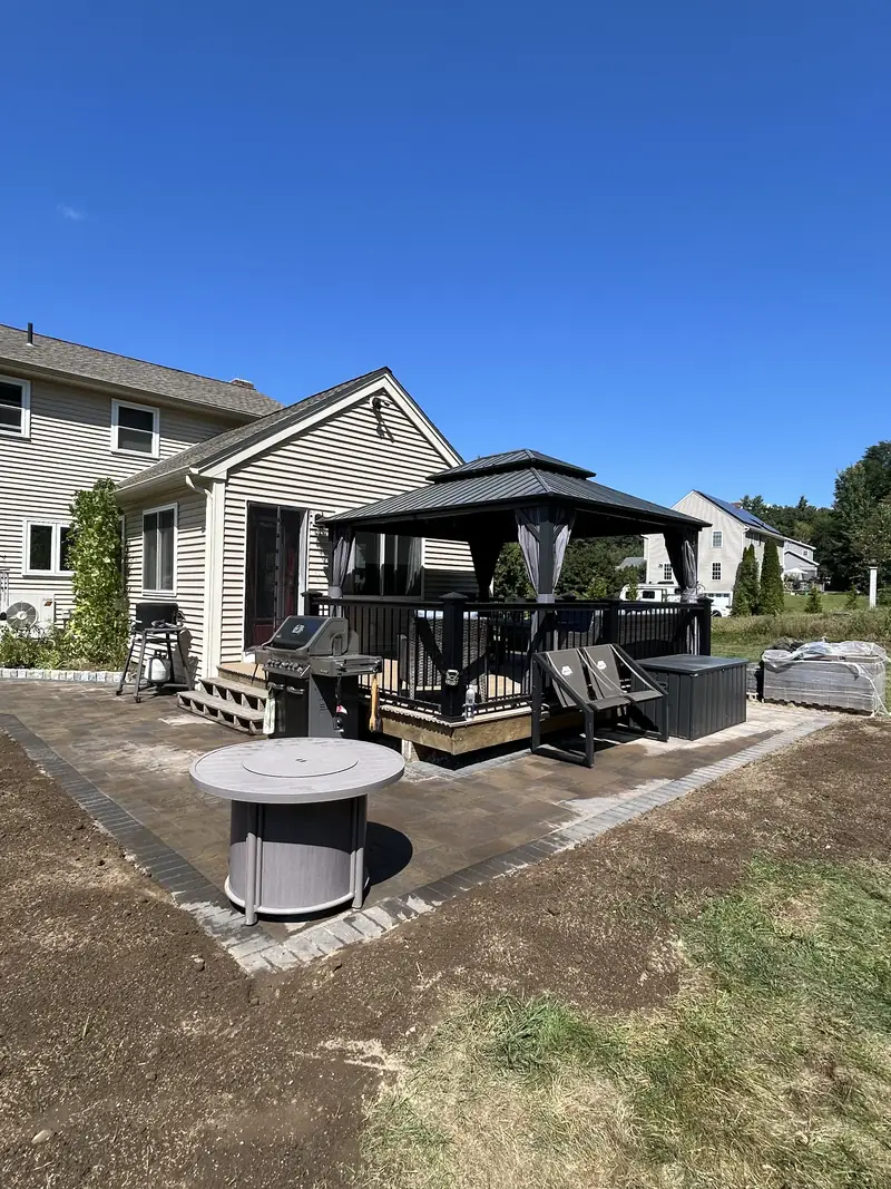 New paver patio with a gazebo and fire pit area