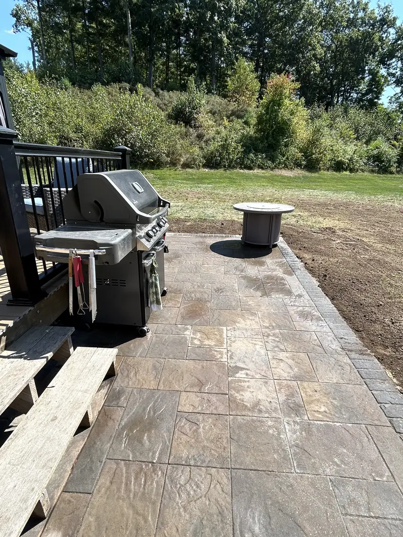 Paver patio leading to a backyard gazebo