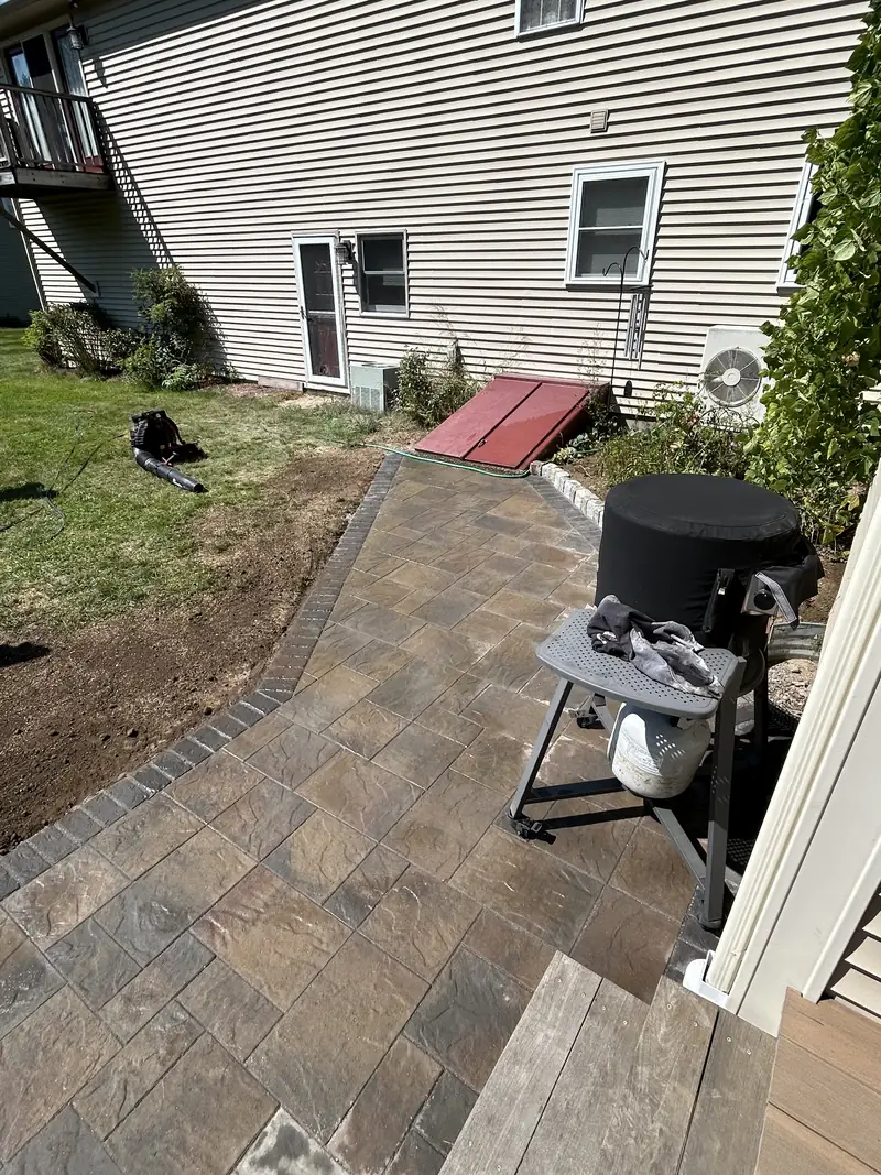 Paver walkway along the side of a home