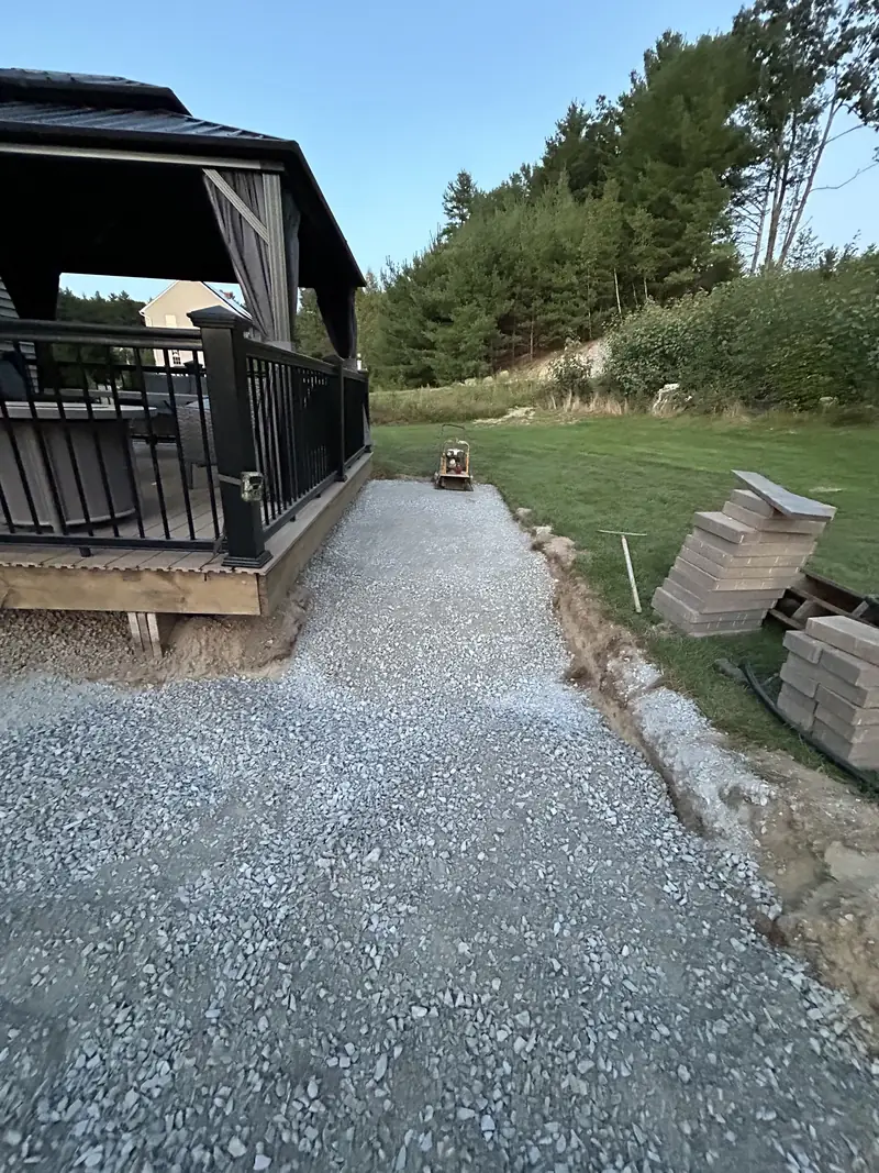 Compacted gravel base prepared for a new patio