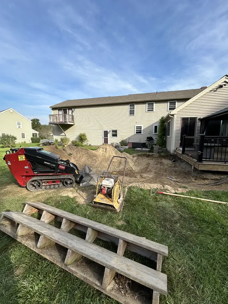 Site prep with a compact track loader for a backyard patio