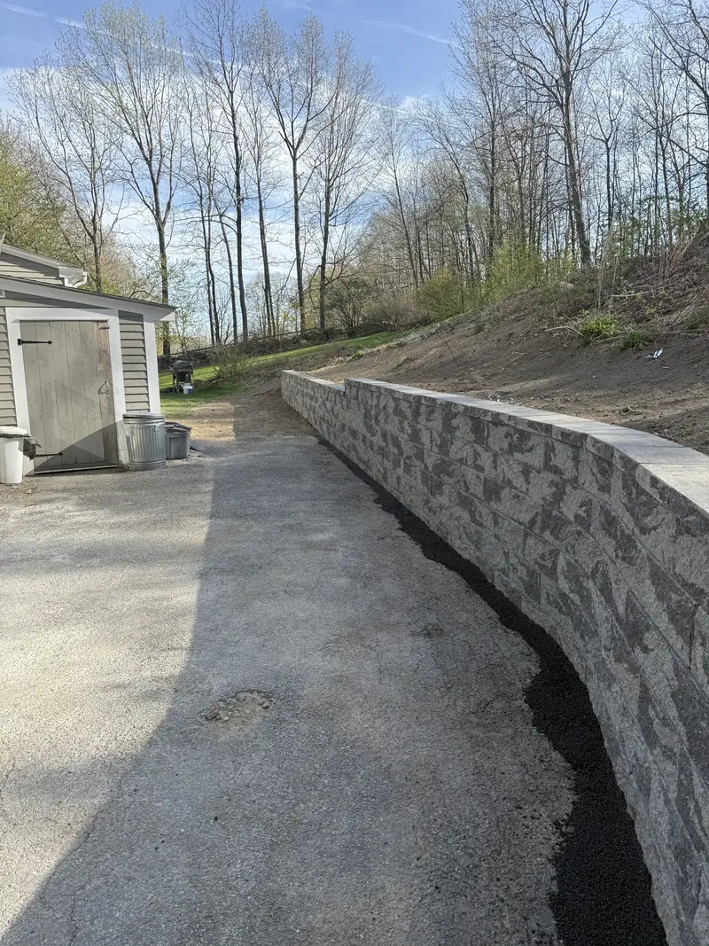 Finished block retaining wall along a driveway