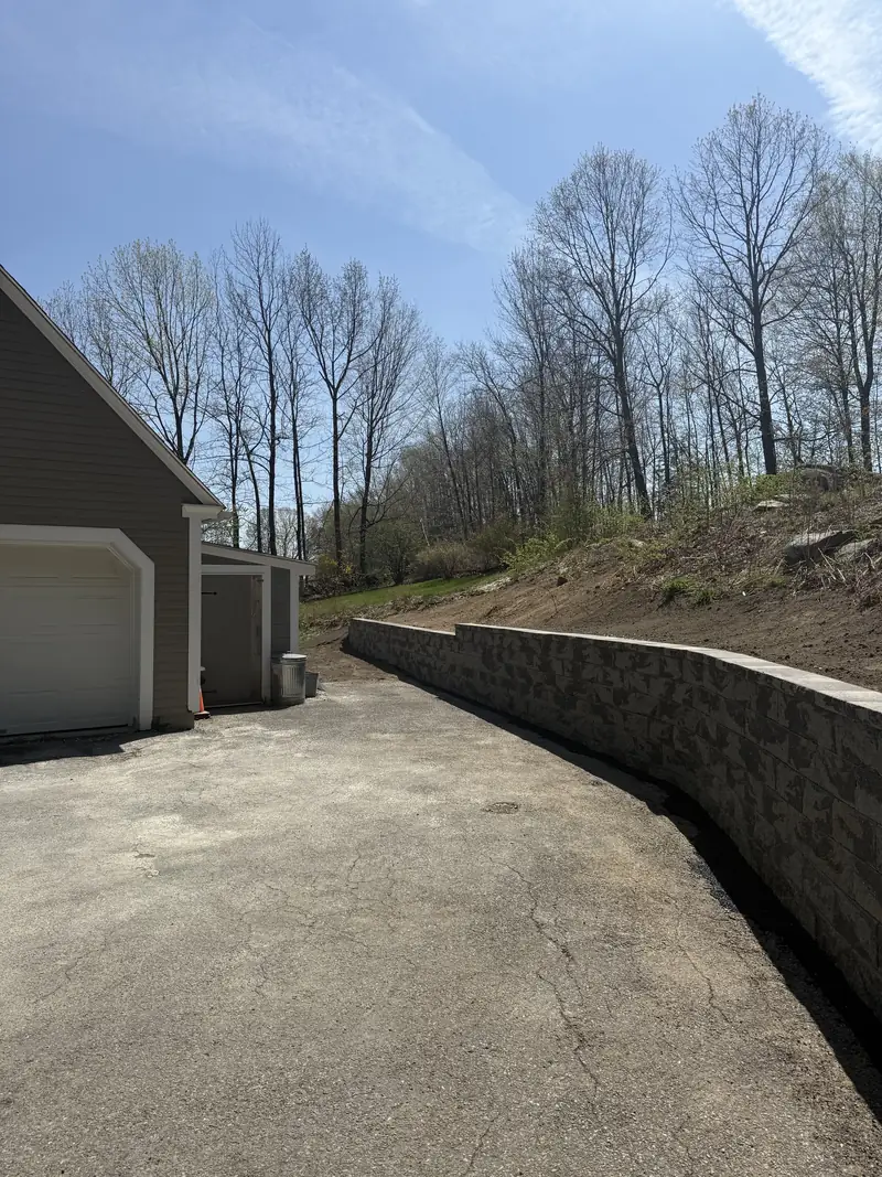 New retaining wall holding a graded slope