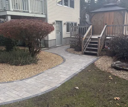 New paver walkway leading to a back deck
