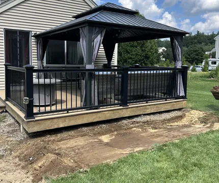 Deck with a gazebo and fresh lawn