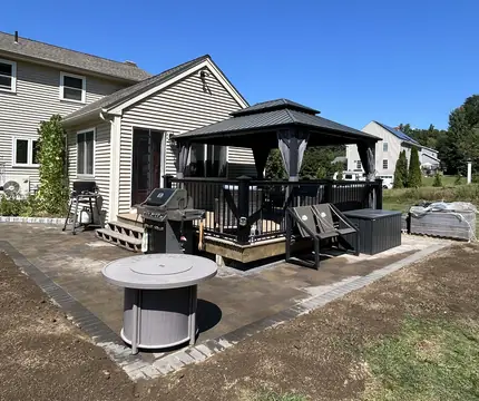 New paver patio with a gazebo and fire pit area