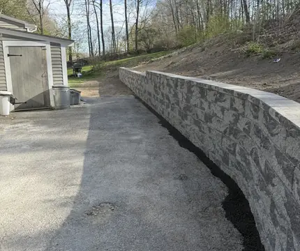 Finished block retaining wall along a driveway